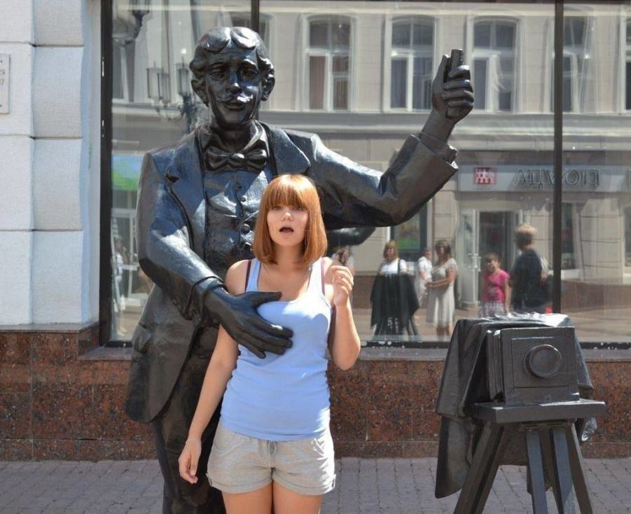Posing with their favorite statues